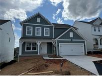 Charming two-story home with a covered front porch and attached two-car garage at 41 Okeechobee Way, Braselton, GA 30548