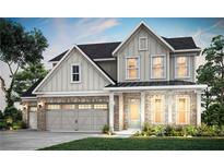 Two-story home with brick and gray siding, complemented by a neatly manicured lawn at 5410 Julep Ct, Cumming, GA 30028