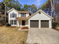 Charming two-story home features a two-car garage and a well-manicured front yard at 9704 Pintail Trl, Jonesboro, GA 30238