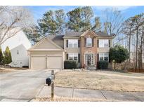Charming two-story home featuring a manicured lawn, brick accents, and a spacious two-car garage at 3550 Myrtlewood Chase Nw, Kennesaw, GA 30144