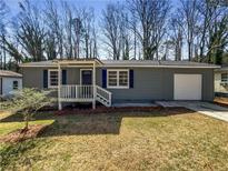 Charming single-story home with gray siding and a well-maintained front yard at 3668 Bunker Hill Sw Dr, Atlanta, GA 30331