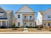 Charming two-story home featuring a covered porch and second-floor balcony, set in a well-maintained yard at 1977 Granite Hills Rd, Atlanta, GA 30318
