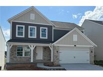 Beautiful two-story home with brick accents, neutral siding, covered entry, and a two-car garage at 61 Okeechobee Way, Braselton, GA 30548