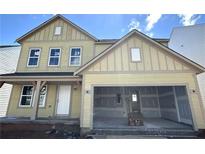 Charming new construction home showcasing a two-car garage and inviting front porch at 61 Okeechobee Way, Braselton, GA 30548