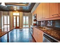 Modern kitchen with stainless steel appliances, granite counters, and tile backsplash at 123 Luckie Nw St # 2510, Atlanta, GA 30303