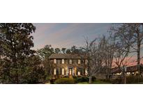 Charming two-story home with black shutters and landscaped yard under a colorful sky at 4481 Windsor Oaks Dr, Marietta, GA 30066