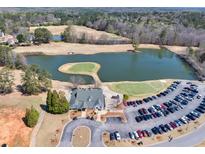 Stunning aerial view of community clubhouse, golf course and pond at 49 Inverness Ct, Hiram, GA 30141