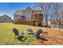 Expansive backyard featuring a fire pit and large deck, perfect for outdoor entertaining at 49 Inverness Ct, Hiram, GA 30141