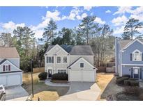 Charming two-story home featuring a two-car garage, landscaped yard, and a classic design at 6005 Pattingham Dr, Roswell, GA 30075