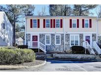Inviting townhome featuring stone accents and red shutters, with a well-maintained front yard landscape at 4008 Bayside Cir, Atlanta, GA 30340