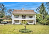 Charming two-story home with a double front porch and well-maintained lawn at 4141 Willow Ridge Rd, Douglasville, GA 30135