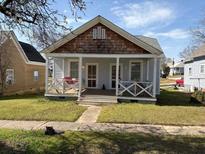 Charming single-story home with a welcoming front porch and well-maintained lawn at 23 Poplar St, Porterdale, GA 30014