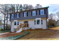 Charming two-story home featuring a gray top, white brick bottom and a landscaped front yard at 2748 Saddle Ridge Lake Dr, Marietta, GA 30062
