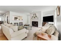 Bright living room features a fireplace, comfortable seating and a pass-through window to the kitchen at 402 Bainbridge Dr, Atlanta, GA 30327