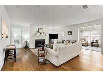 Bright and airy living room with hardwood floors, a fireplace, and comfortable seating at 402 Bainbridge Dr, Atlanta, GA 30327