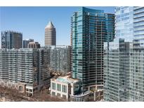 Stunning condo exterior showing glass high rise building with beautiful cityscape view on a bright sunny day at 1080 Peachtree Ne St # 2011, Atlanta, GA 30309