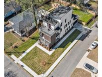 Stunning aerial view of a modern two-story home showcasing its manicured lawn and neighborhood surroundings at 662 S Grand Nw Ave, Atlanta, GA 30318