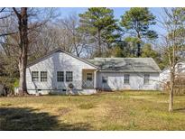 Classic one-story home with a welcoming entrance and a spacious front yard perfect for outdoor activities at 3480 Beech Dr, Decatur, GA 30032