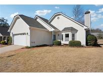 Attractive stucco home featuring an attached garage and manicured landscaping at 4010 Arborwood Ln, Tucker, GA 30084