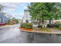 Charming townhome featuring a two-car garage, second story balcony, and professionally landscaped yard at 50 Sycamore Sta, Decatur, GA 30030