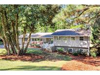 Charming single-Gathering home featuring mature trees, a manicured lawn, and inviting curb appeal at 1464 Sagamore Ne Dr, Atlanta, GA 30345