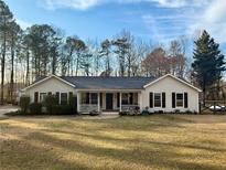 Charming one-story home featuring a well-manicured lawn and a welcoming front porch at 4835 John Burruss Rd, Cumming, GA 30040