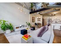 Open-concept living room with high ceilings, modern lighting, and a comfortable seating area at 400 Village Ne Pkwy # 114, Atlanta, GA 30306