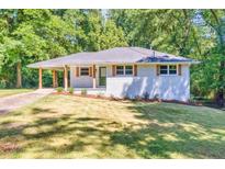 Charming brick home with well-maintained lawn and covered entry at 1875 Creekside Ct, Decatur, GA 30032