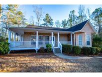 Charming single-story home with a welcoming front porch and well-maintained landscaping at 7153 Tara Dr, Villa Rica, GA 30180