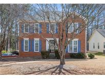 Charming two-story brick home with blue shutters and a well-maintained front lawn at 1370 Wheatfield Dr, Lawrenceville, GA 30043