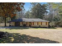 Charming single-story home with a welcoming front porch and a well-maintained lawn at 3948 Lake Carlton Road S Rd, Loganville, GA 30052