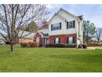 Charming two-story home with brick accents, well-maintained lawn, and mature landscaping at 494 Martin Forest Ln, Lawrenceville, GA 30045