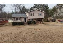 Charming two-story home featuring a well-maintained lawn and an attached garage at 182 Iris Ct, Riverdale, GA 30274