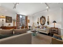 Comfortable living room with a neutral color palette and large windows offering city views at 1421 Peachtree Ne St # 415, Atlanta, GA 30309