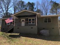 Charming home exterior with a welcoming front porch and American flag waving proudly at 23 Holub Path, Dallas, GA 30157