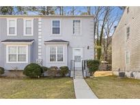 Charming two-story townhome with a well-maintained lawn and inviting front entrance at 5940 Hampton Ct, Atlanta, GA 30349