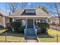 Charming bungalow-style home with a well-maintained front yard and a secure iron fence at 1000 Beckwith Sw St, Atlanta, GA 30314