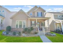 Charming home featuring a covered front porch, manicured lawn and tasteful landscaping enhancing curb appeal at 145 Treeside Ter, Fayetteville, GA 30214