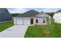 Charming single-story home showcasing a well-manicured lawn and a two-car garage at 246 Orwell Dr, Social Circle, GA 30025