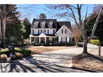 Charming two-story home with a well-manicured lawn and a long driveway at 539 Wintergreen Way, Canton, GA 30115