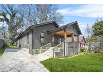 Charming home featuring a cozy front porch, concrete driveway, and well-maintained lawn at 1147 Oakland Sw Dr, Atlanta, GA 30310