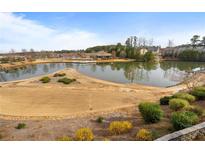 Scenic pond view with a charming gazebo and well-manicured landscaping in a tranquil community setting at 348 Lauren Ln, Woodstock, GA 30188