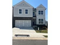 Charming two-story home with a two-car garage, stone accents, and a well-manicured lawn at 270 Lakeside Pl, Canton, GA 30114