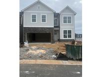 Two-story exterior elevation with an open garage and stone accents at the base of the home at 270 Lakeside Place, Canton, GA 30114
