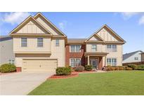 Charming two-story home with a well-manicured lawn and attached two-car garage at 4397 Challedon Dr, South Fulton, GA 30213