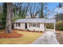Charming bungalow with a well-manicured front yard and covered parking at 3173 Canary Ct, Decatur, GA 30032