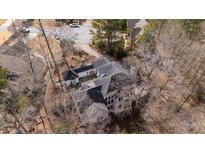 An aerial view of the home's unique architecture, nestled amongst a canopy of trees at 1458 Sweet Bottom Cir, Marietta, GA 30064
