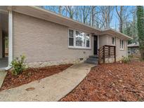 Charming one-story brick home with a walkway leading to the front door and a well-maintained yard at 1883 Windsor Sw Dr, Atlanta, GA 30311