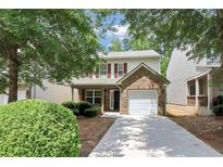 Charming two-story home featuring red shutters, a brick accent, and a single-car garage at 4678 Ravenwood Loop, Union City, GA 30291