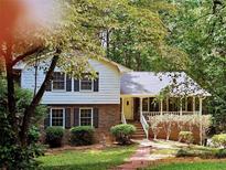 Charming two-story home with brick and siding exterior, black shutters, and a welcoming front porch at 745 Queen Ann Ct, Stone Mountain, GA 30083